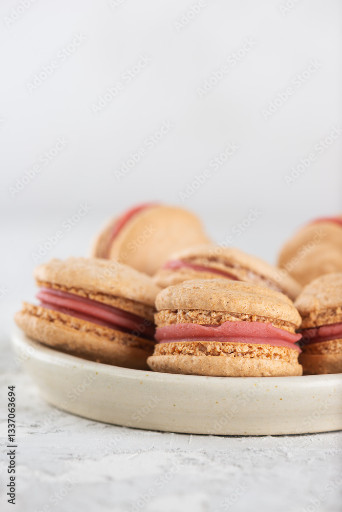Vegan homemade caramel macarons with raspberry cream on shea butter. Sugar, lactose and gluten free. Vertical orientation. Vegan homemade caramel macarons with raspberry cream on shea butter. Sugar, lactose and gluten free. Vertical orientation.