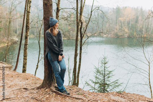 Obraz na płótnie Fall autumn hiker woman outdoor at nature forest and lake for camping travel. Scenery of the majestic lake. Active lifestyle. Travel concept. High quality photo. Full body w salonie