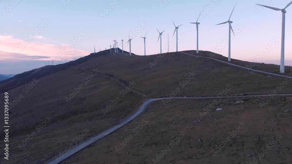eolic aerogenerators spining wth the strong wind at sunset on a windy hi