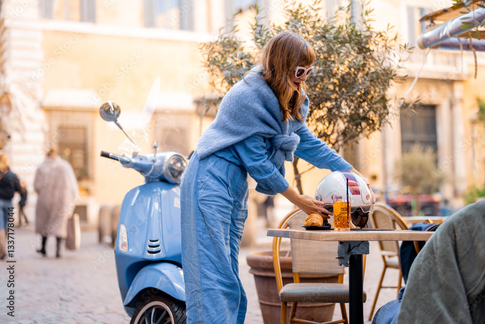 A fashionable Italian woman in a stylish blue outfit arrives on a scooter for an aperitivo at a charming Roman cafe
