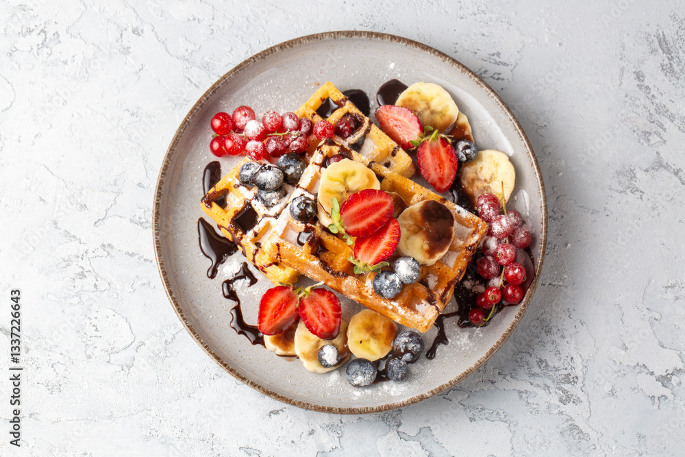 Delicious fresh baked belgian waffles with berries and fruit