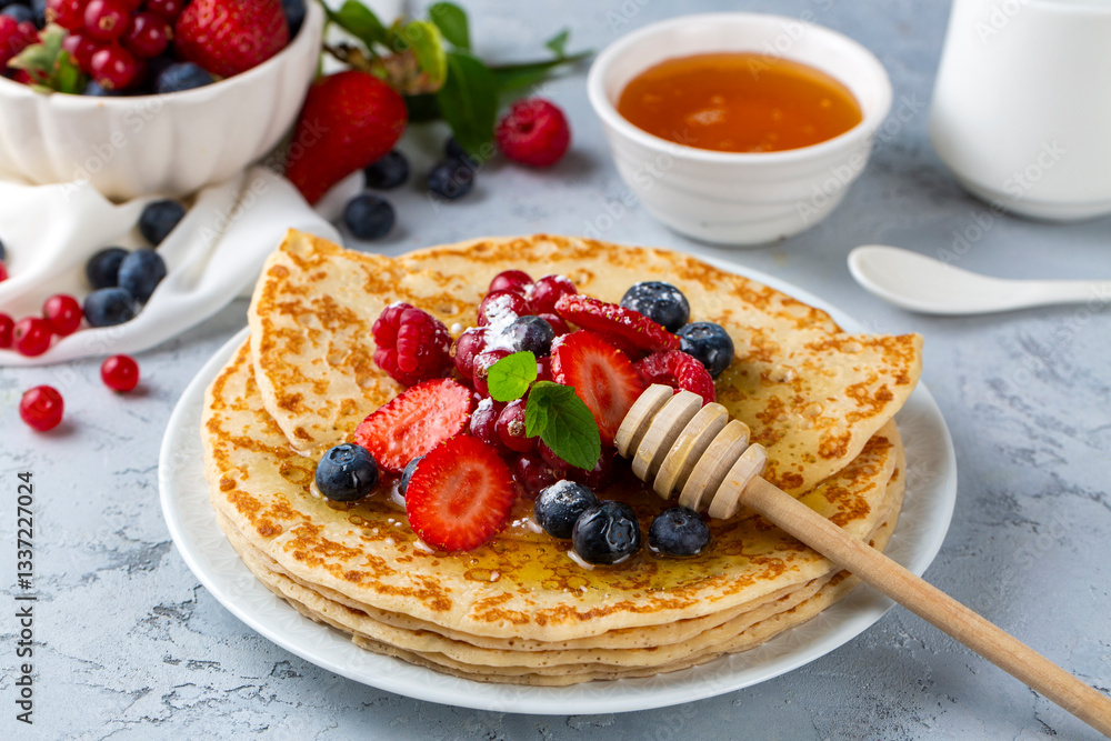 Healthy summer breakfast, homemade classic crepe with fresh fruit and honey
