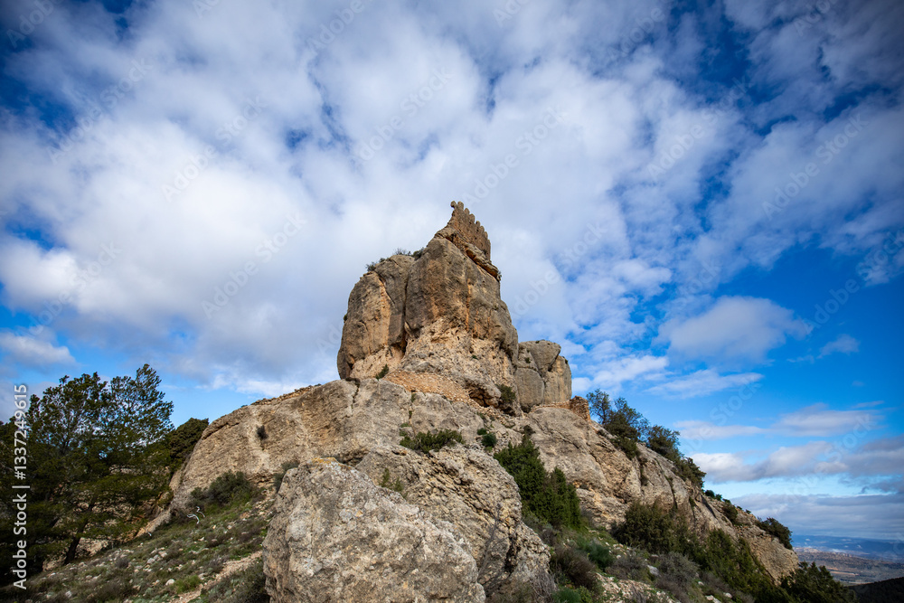 Spectacular view of Benizar Castle, perched on a rock in the town of La Tercia, Moratalla, Murcia Region, Spain. Spectacular view of Benizar Castle, perched on a rock in the town of La Tercia, Moratalla, Murcia Region, Spain.