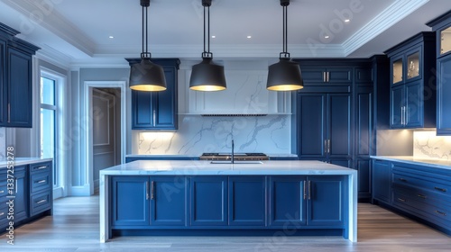 A luxurious kitchen with deep blue cabinets and a white marble countertop featuring soft gray veining