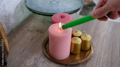 Lighting Colorful Scented Candles in a Tray on a Wooden Table with a Lighter Hand Close-Up