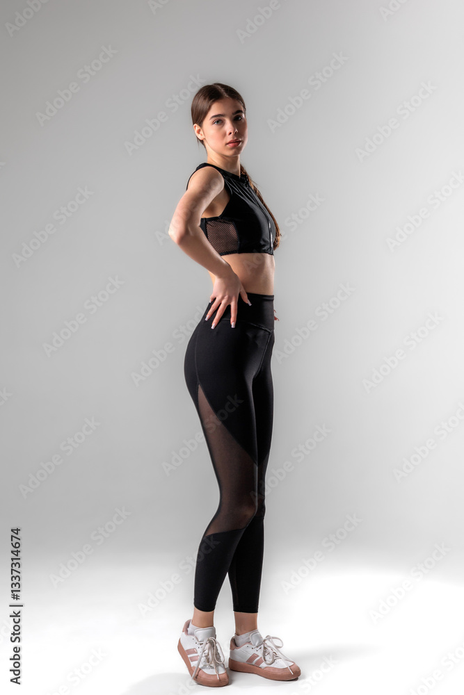 Fitness model showcasing activewear in a studio setting during a fashion shoot Fitness model showcasing activewear in a studio setting during a fashion shoot