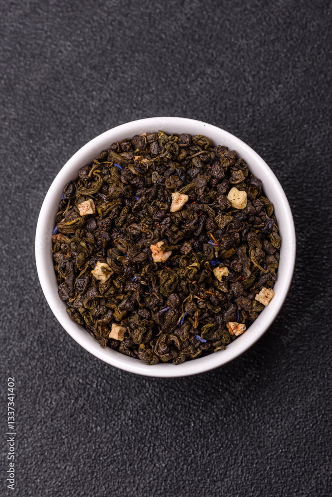 Dry green tea with soursop piece, knapweed petals in bowl Dry green tea with soursop piece, knapweed petals in bowl