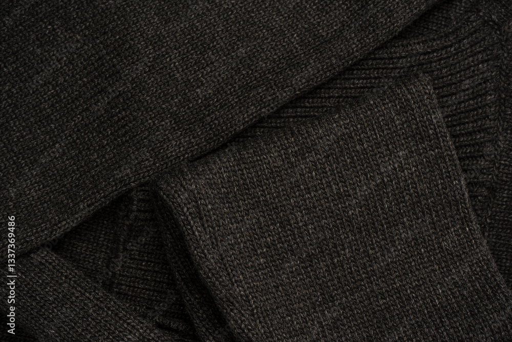 Fototapeta premium Dark grey sweater texture as a background. Knitted pattern.