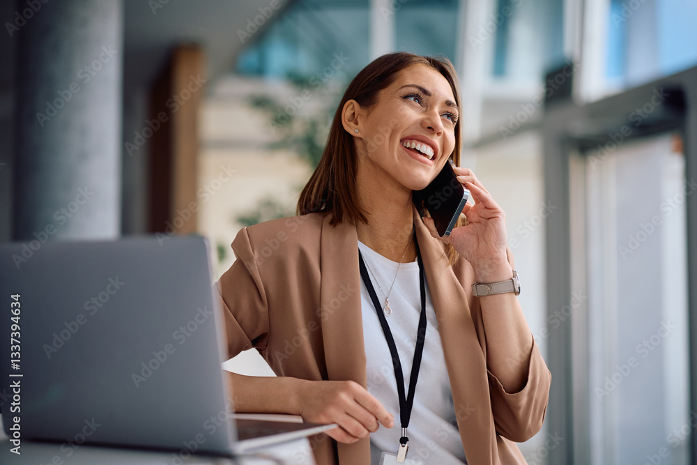 Happy female entrepreneur talking on phone while working in office. Happy female entrepreneur talking on phone while working in office.