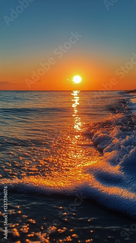 Beautiful Sunset Over Calm Ocean With Gentle Waves Reflecting Golden Light