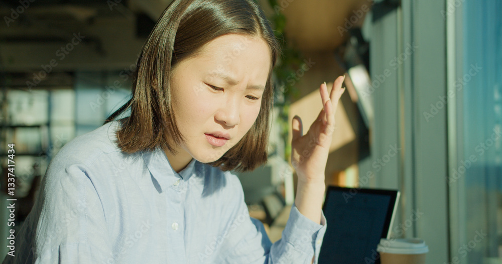 A young woman deeply focused while working in a modern office, expressing concern as she reviews documents, with sunlight streaming through large windows A young woman deeply focused while working in a modern office, expressing concern as she reviews documents, with sunlight streaming through large windows