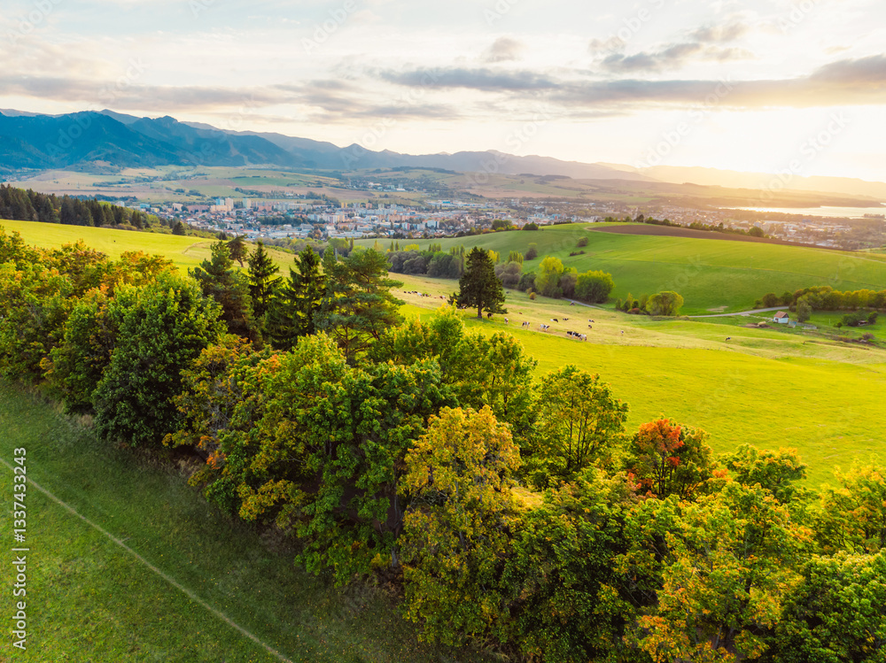 Obraz premium Sunset over Liptov region with Liptovska Mara lake and Tatras mountains around. Liptovsky mikulas landspace, slovakia.