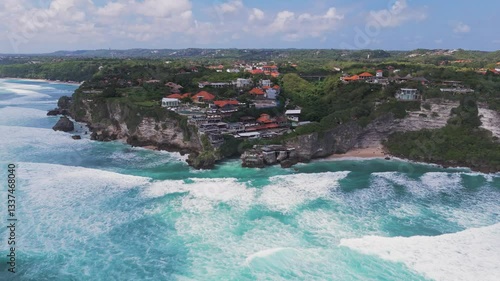 Aerial view of a Bali surf spot with rolling ocean waves