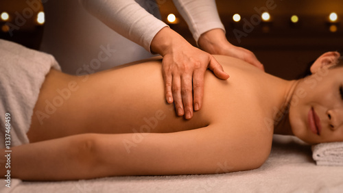 Wallpaper Mural Peaceful young woman having relaxing body massage at newest luxury spa decorated with candles. Female therapist rubbing sleeping lady back, giving relaxing and body care session, side view Torontodigital.ca