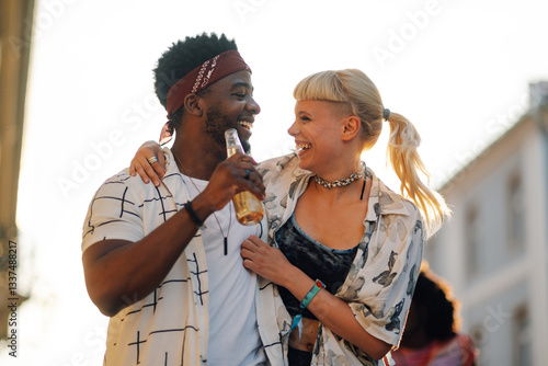 Photography Happy multiethnic couple drinking beer at summer music festival