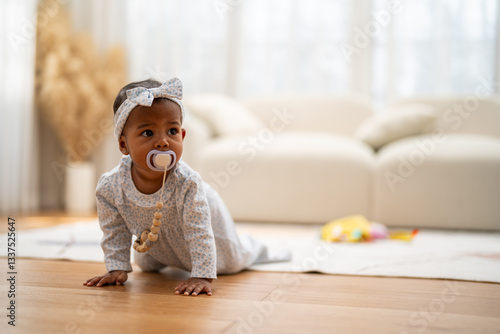 Принти на полотні Cute african baby with pacifier crawling on floor, innocent childhood at home, s