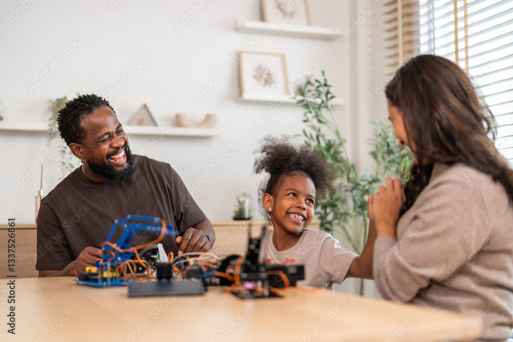 African love family, father mother and daughter learning STEM education, science experiment, robotics toy, technology and innovation interactive learning, creativity and development at home African love family, father mother and daughter learning STEM education, science experiment, robotics toy, technology and innovation interactive learning, creativity and development at home