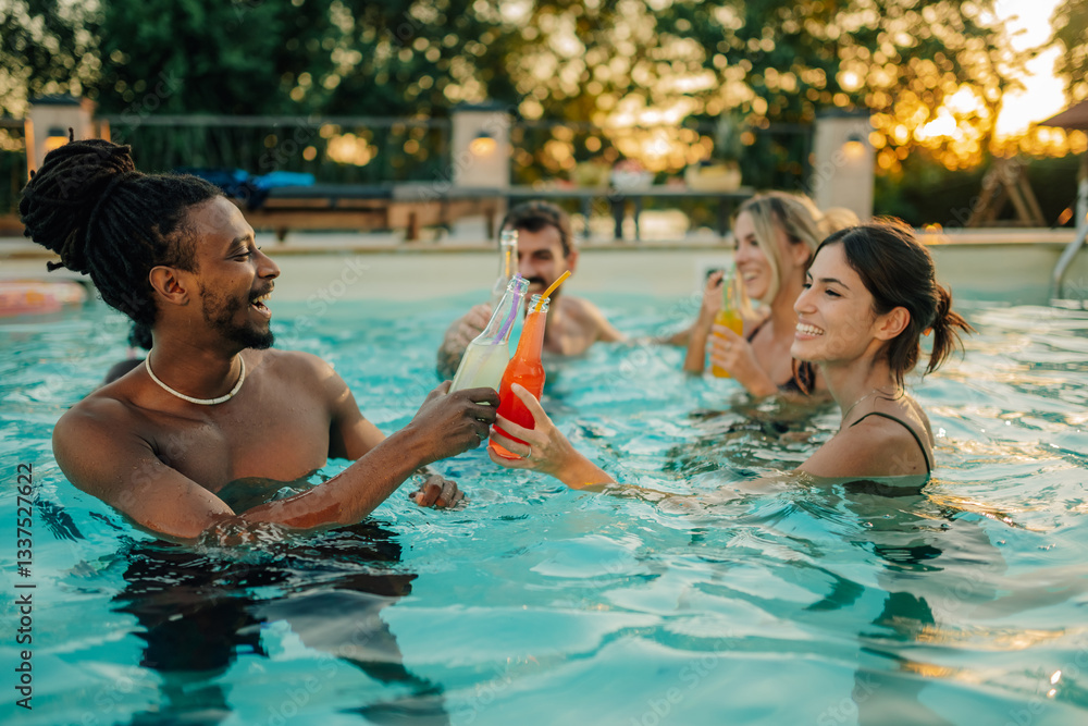 Friends toasting with bottles of juice in swimming pool during summer party Friends toasting with bottles of juice in swimming pool during summer party