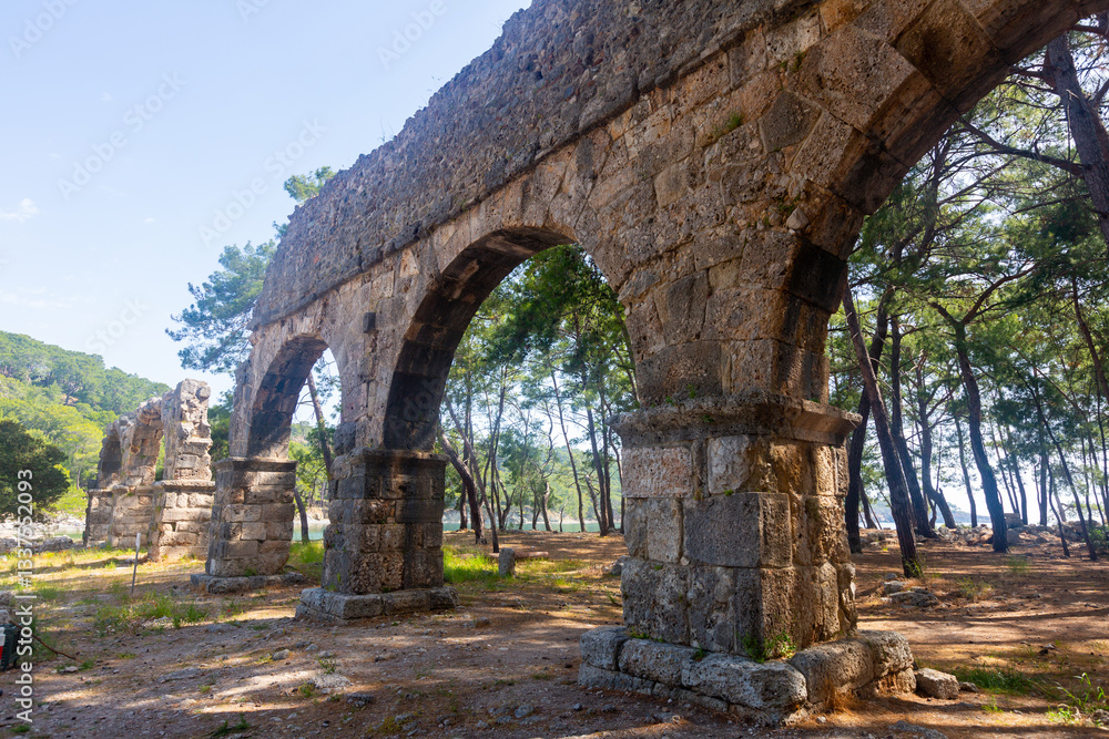 Ruins of aquaeduct in ancient city Phaselis, Antalya Province, Turkey. Lycian ancient civilization heritage. Ruins of aquaeduct in ancient city Phaselis, Antalya Province, Turkey. Lycian ancient civilization heritage.