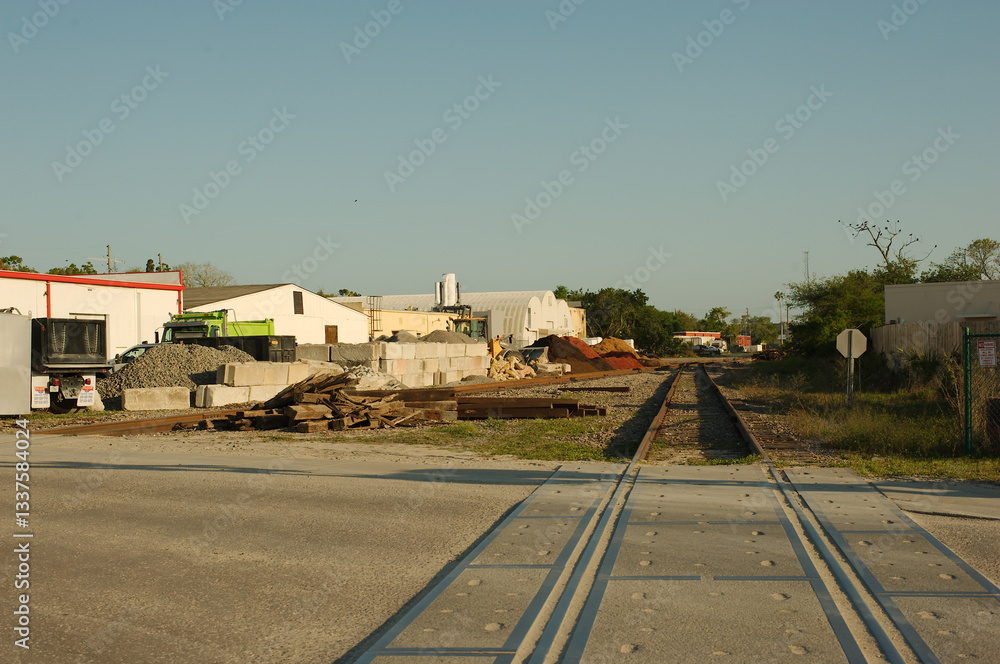Leading lines down railroad tracks. Concrete plant industrial facility and building material supply. In the background are industrial buildings. Near sunset.
Leading lines down railroad tracks. Concrete plant industrial facility and building material supply. In the background are industrial buildings. Near sunset.