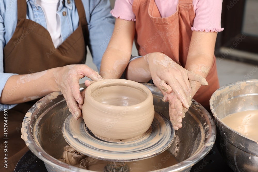 Hobby and craft. Mother with her daughter making pottery indoors, closeup Hobby and craft. Mother with her daughter making pottery indoors, closeup
