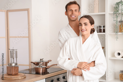 Young couple in bathrobes h...