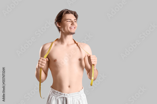Young man with tape measure...