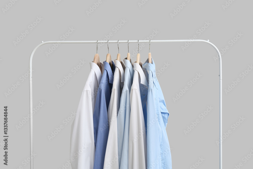 Obraz premium Rack with stylish collar shirts on grey background