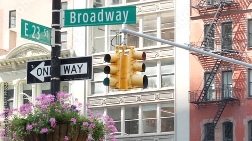 Broadway street road sign, Manhattan midtown architecture, New York City corner. Yellow traffic light. Flatiron district near Madison Square Park. Crossroad of 23 st., Bway and 5 Fifth avenue. One way