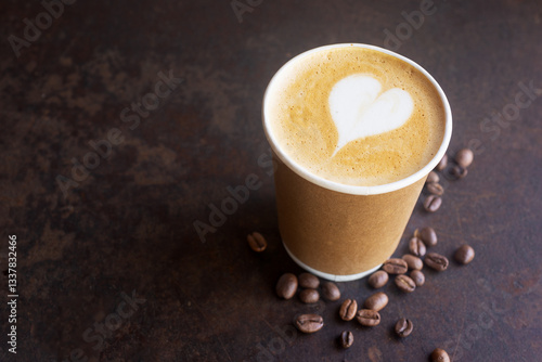 hot latte coffee in takeaway paper coffee cup, ready to go coffee on brow rustic table.