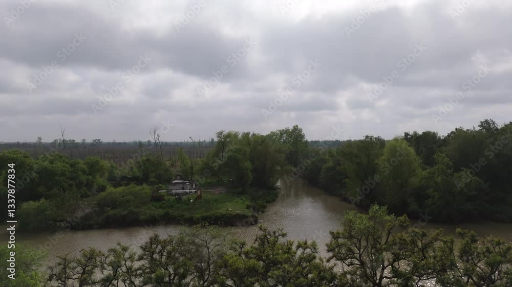 Isolated island with abandoned house on misty river, surrounded by dense green forest Isolated island with abandoned house on misty river, surrounded by dense green forest