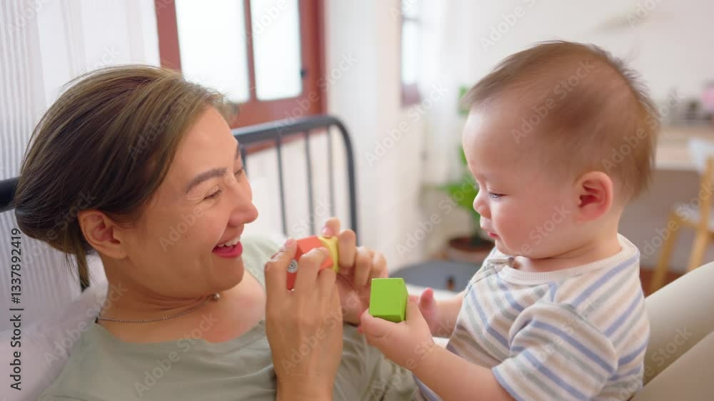 Asian single mother lovingly cares for and raises her baby boy at home. Asian single mother lovingly cares for and raises her baby boy at home.