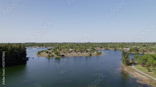 Wallpaper Mural Establishing drone shot of lake in Okeeheelee Park during the day with sun shining and blue sky in West Palm Beach, Palm Beach County, Florida, USA Torontodigital.ca