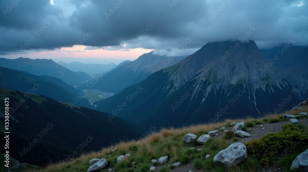 Fototapeta premium The Apennines (Gran Sasso d’Italia, Majella) during dusk with rainy weather, captured from a panoramic perspective, featuring misty mountains and a dynamic sky.