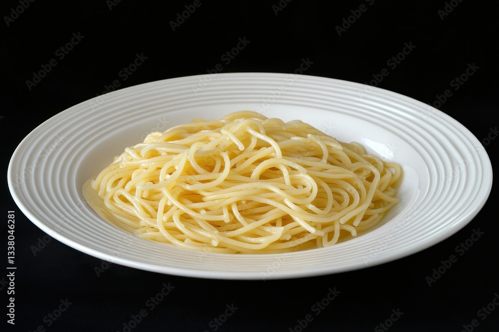 Plain spaghetti served on a white plate, isolated against a black backdrop. Showcase classic Italian cuisine, or ingredients for easy, home-cooked meals. Plain spaghetti served on a white plate, isolated against a black backdrop. Showcase classic Italian cuisine, or ingredients for easy, home-cooked meals.