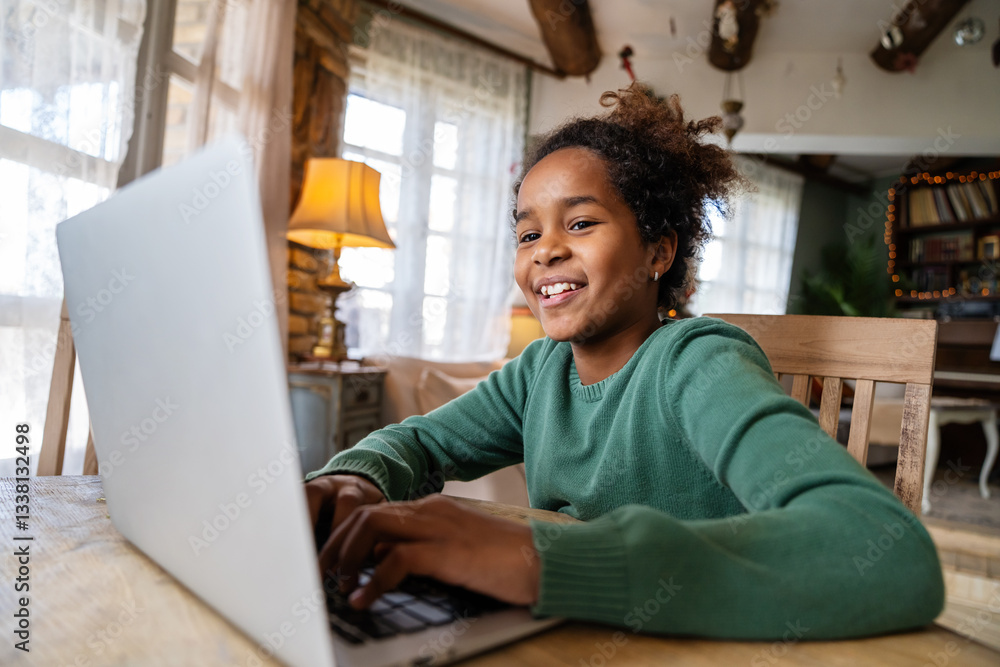 Naklejka premium Portrait of teenage black girl playing video games online on laptop. Social media livestream concept