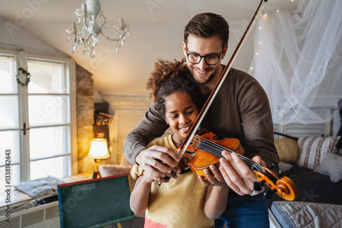 Obraz na płótnie Private music man teacher giving violin lessons to African American girl at home w salonie