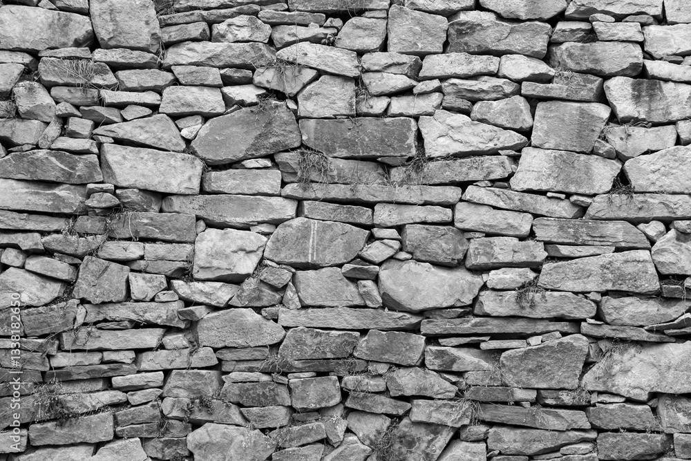 Fototapeta premium Texture of an old stone wall in black and white