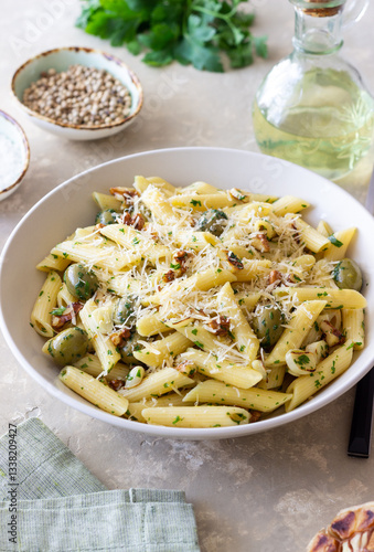 Schilderij op canvas Pasta penne with olives, nuts, herbs and cheese