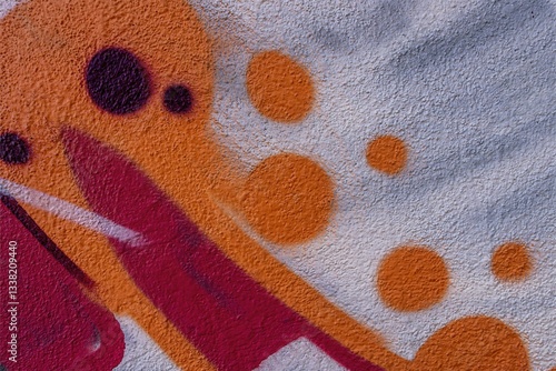 abstract and textured background of a colorful urban street wall with aerosol painted graffity pattern with concret texture