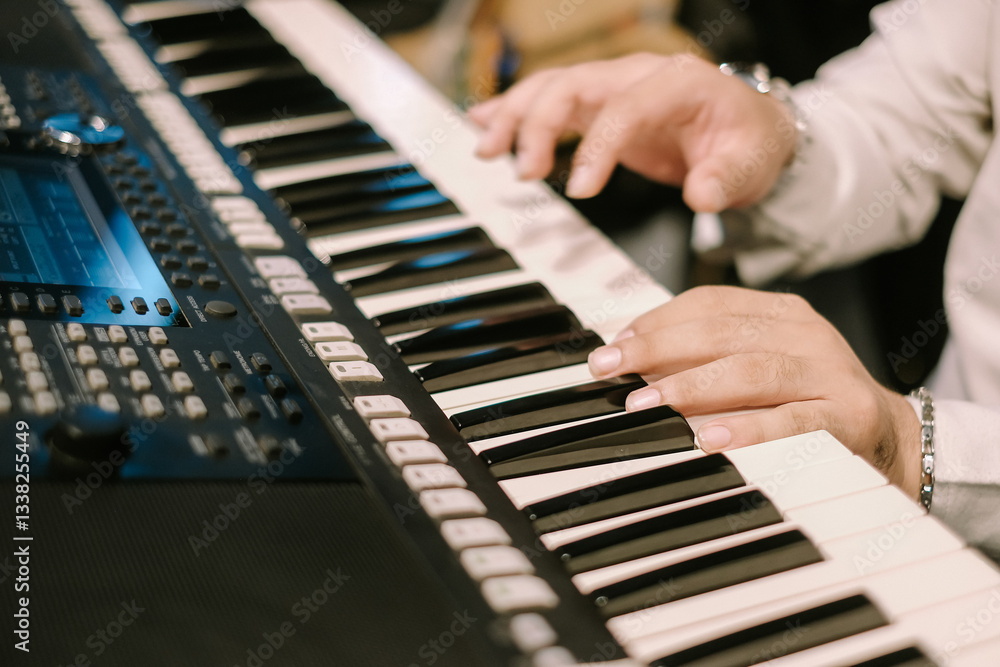 Obraz premium Hands playing electronic keyboard instrument close up view music scene