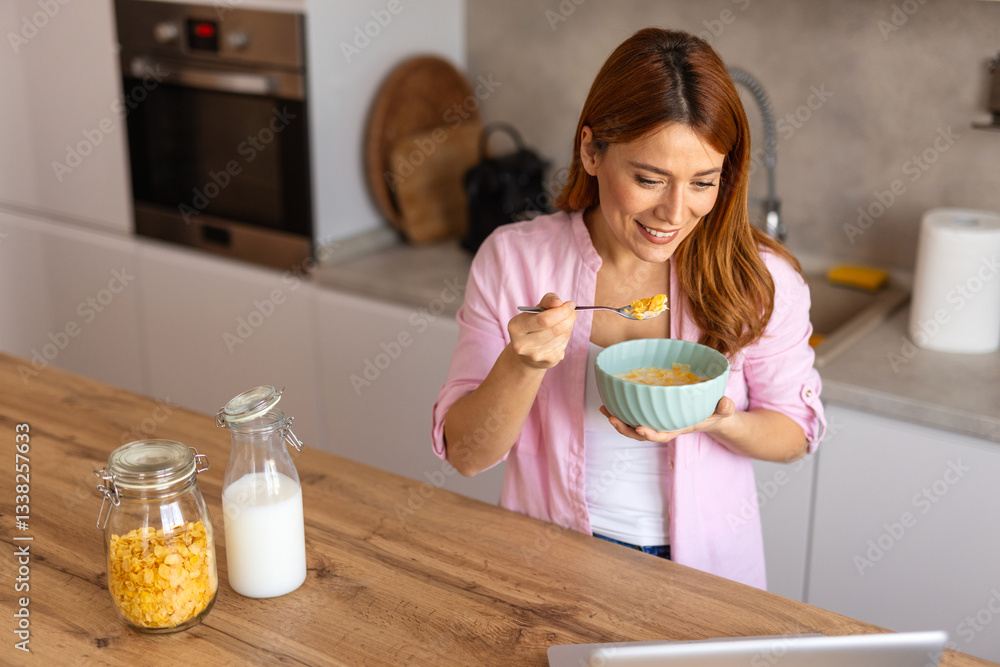 woman in a cozy kitchen prepares a healthy breakfast, pouring milk into a bowl of cereals. She enjoys a peaceful morning routine, embracing a nutritious start to the day. woman in a cozy kitchen prepares a healthy breakfast, pouring milk into a bowl of cereals. She enjoys a peaceful morning routine, embracing a nutritious start to the day.