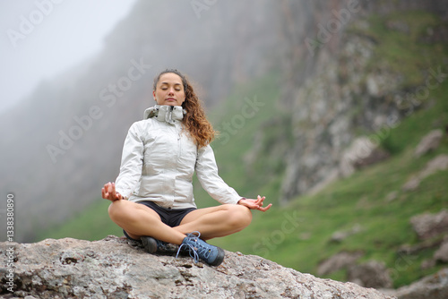 Trekker doing yoga exercise in the mountain