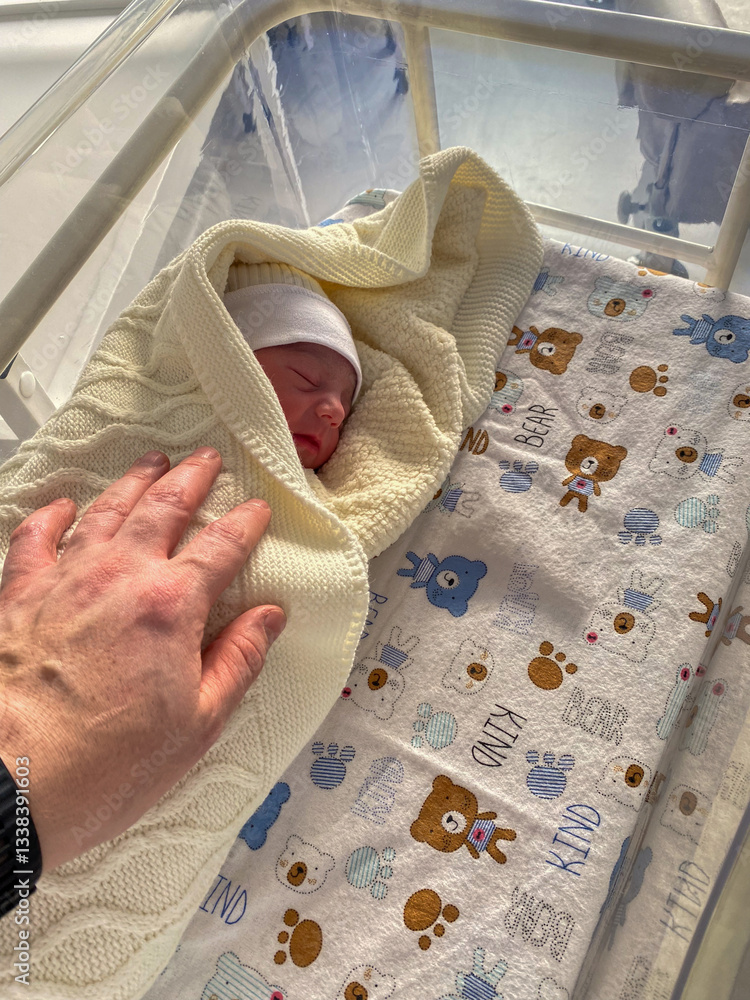 Newborn Baby in Hospital Bassinet with Bear Sheet