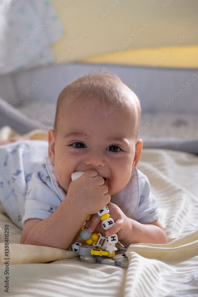 Happy Baby Playing with Toys on a Blanket