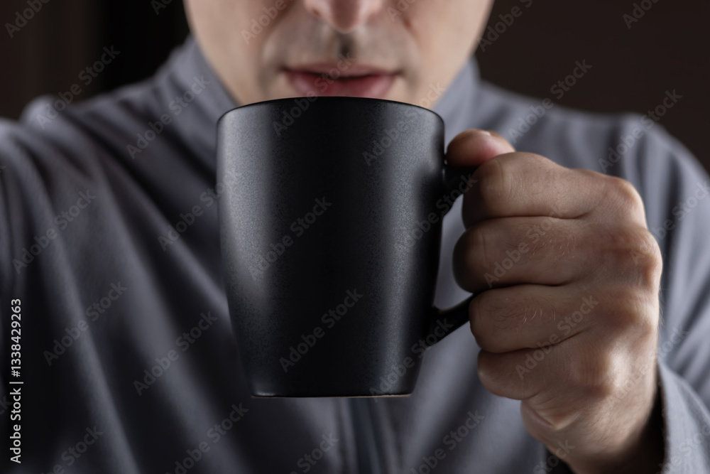 Men hold black cup in hands close up Men hold black cup in hands close up