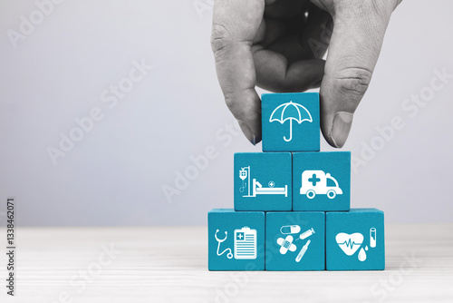 Wooden blocks with medical service icons and umbrella representing protection. Health insurance planning Concept, financial risk protection for medical expenses, and assisting in managing health risks