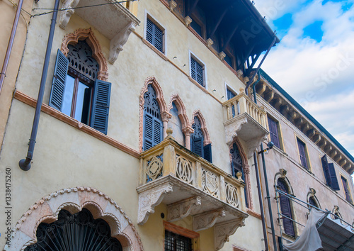 Fototapeta Naklejka Na Ścianę i Meble -  Verona, Italy. Traditional colorful building with balconies, shutter windows and multicolored walls in typical italian street