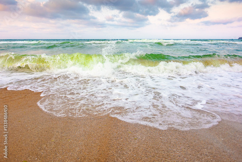 nature background with sea tide. water surface motion at storm. wave splash with foam on the wet beach. summer outdoor weather with wind. beautiful view of travel wallpaper with horizon