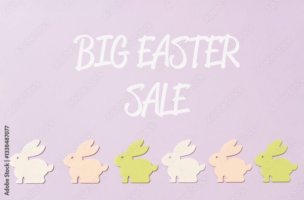 Purple background with a row of rabbits and the words Big Easter Sale written above them Purple background with a row of rabbits and the words Big Easter Sale written above them